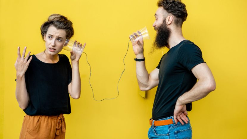 Two people talking on string phone