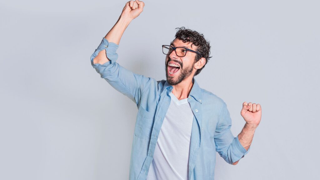 Excited man who now understands the Difference between CCaaS and UCaaS